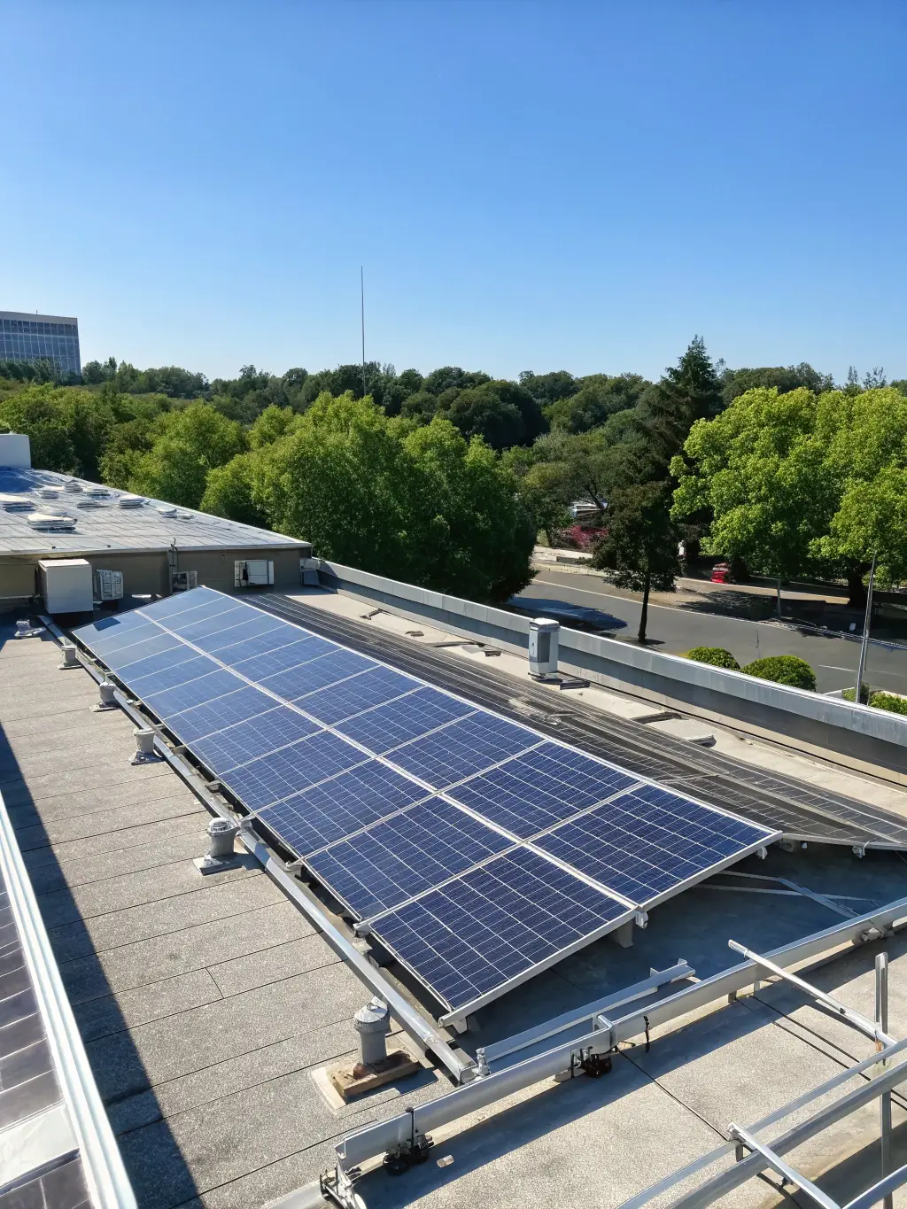 A commercial building with a large array of solar panels on its roof, showcasing a commitment to sustainability and reduced energy costs.